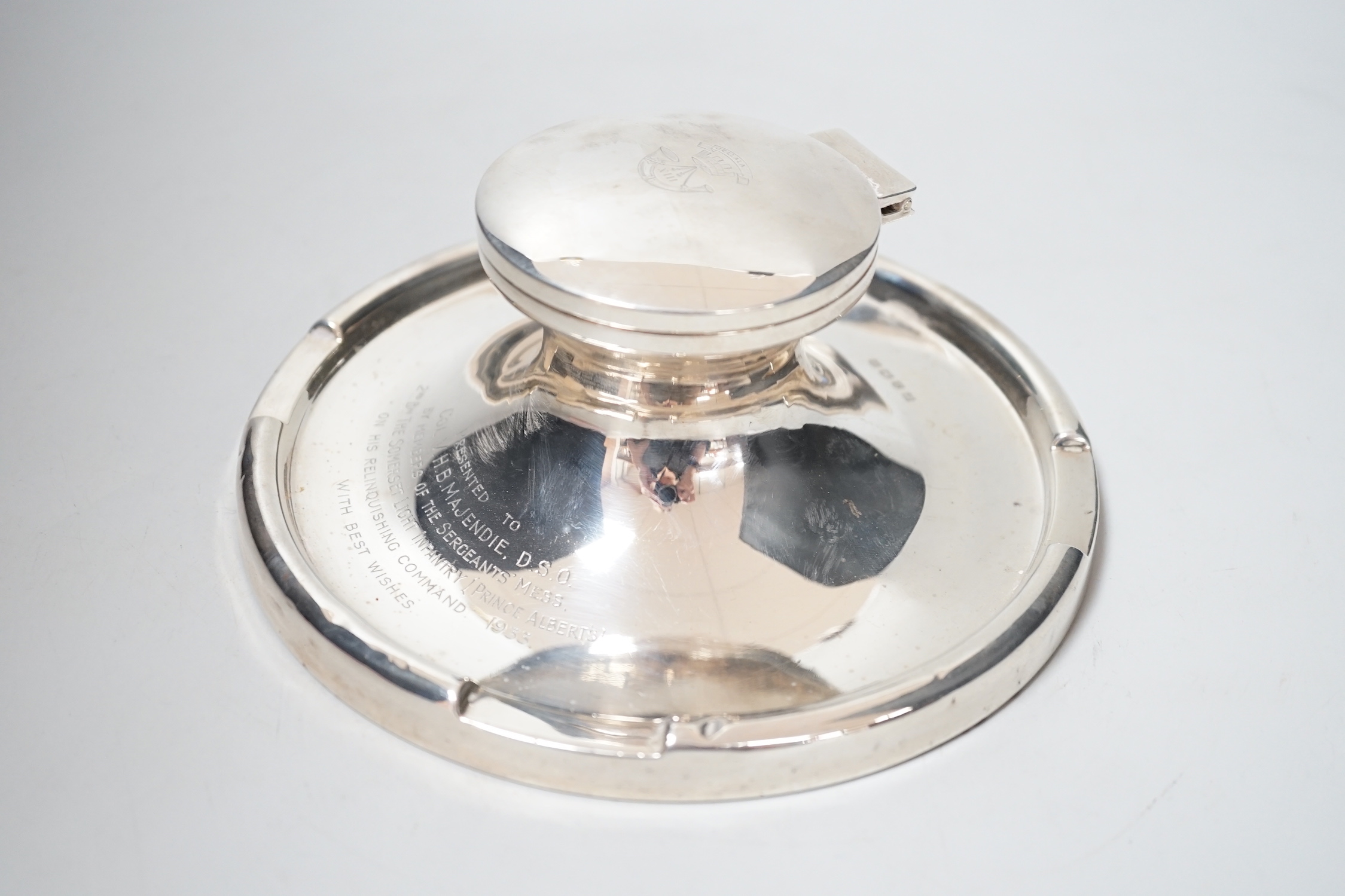 A George V silver mounted capstan inkwell, with Light Infantry related inscription, A & J Zimmerman, Birmingham, 1931, diameter 17.7cm.